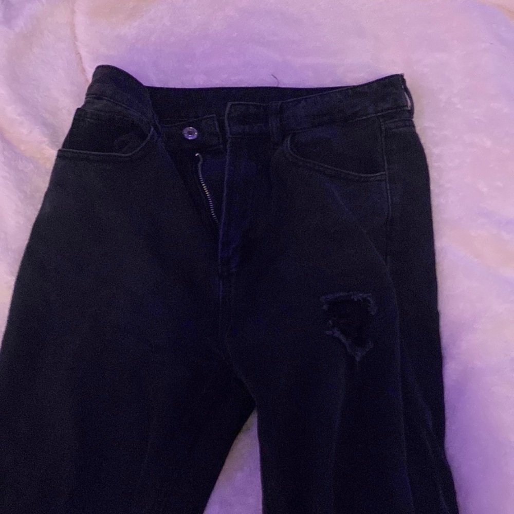 Woman’s black ripped jeans